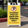 Student pickup A-frame sign standing on a sidewalk