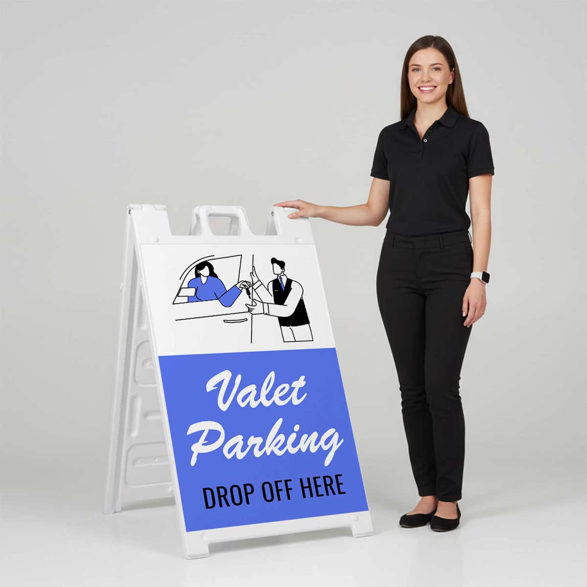 Woman standing beside a valet parking A-frame sign for scale