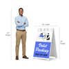 Valet parking A-frame sign shown with size dimensions beside a man