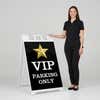 Woman standing beside a VIP parking A-frame sign for scale