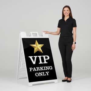Woman standing beside a VIP parking A-frame sign for scale
