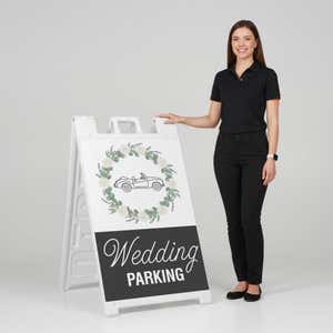 Woman standing beside a wedding parking A-frame sign for scale
