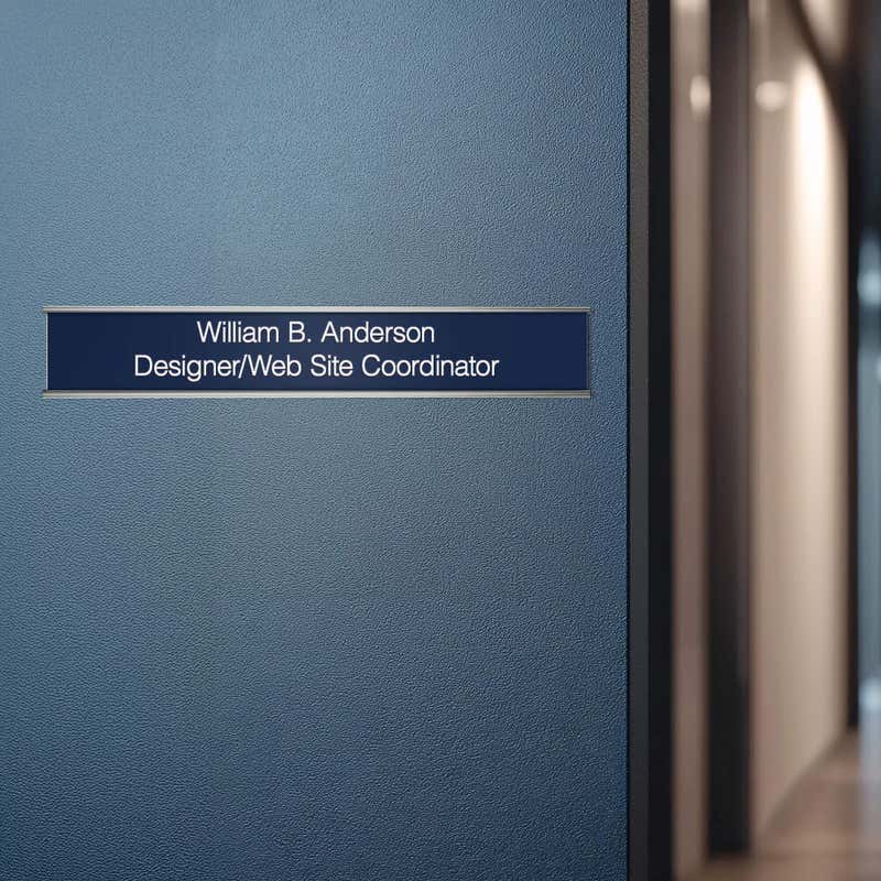 A blue name plate with a silver aluminum wall holder on an office door