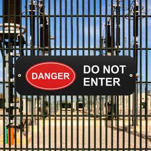 Black sign that reads “Do Not Enter” in white and red oval Danger Icon in white text