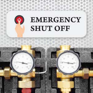 White sign with bold black text that reads “Emergency Shut Off” and an icon showing red power button pressed down by a hand