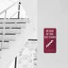 Vertical ADA sign for a fire exit by stairs