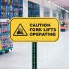 A Yellow Aluminum Caution Sign for a Fork Lifts Operating