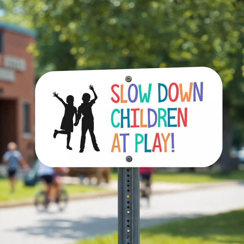 Custom traffic safety sign with a child icon that reads in colorful text: Slow Down Children At Play!