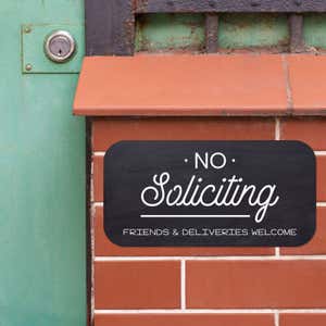 Black background custom 6”x12” sign that reads No Soliciting, Friends and Deliveries Welcome
