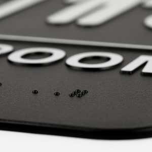Close up of the Braille on the sign