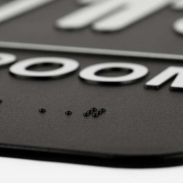Close up of the Braille on the sign