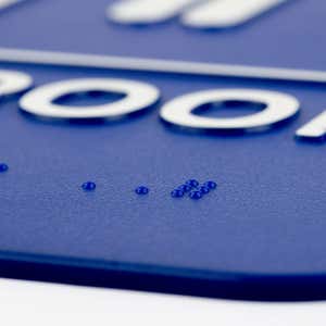 Close up of the Braille on the sign