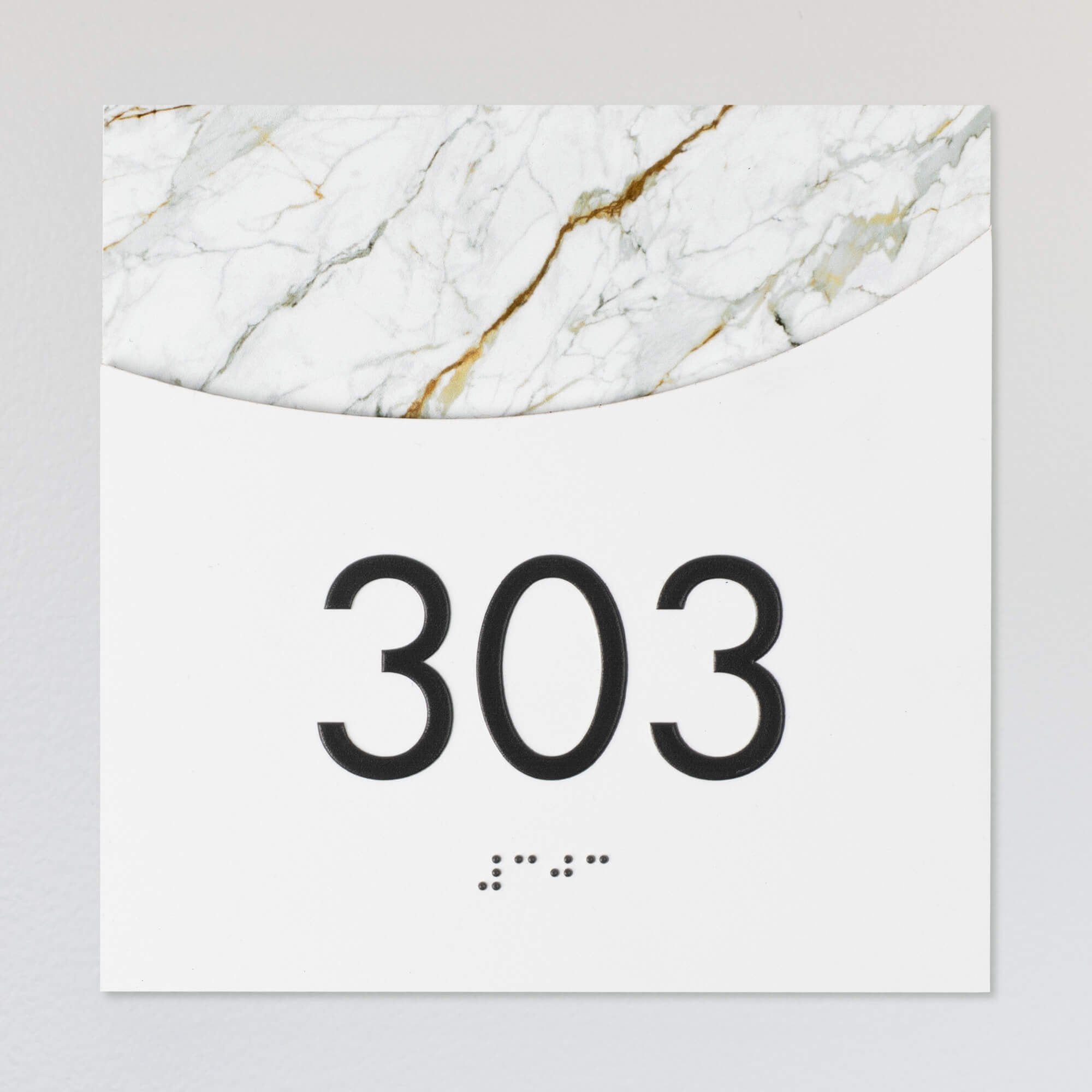A layered ADA sign for a room number with a white foreground and the white marble background A layered ADA sign for a room number with a white foreground and the white marble background
