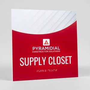 An example of a 2-layered modern arch ADA design for a supply closet with a red foreground and the minimal diagonal background