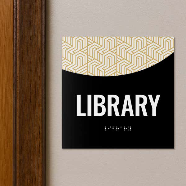 A 2-layered ADA sign for a library with a black foreground and modern geometric background