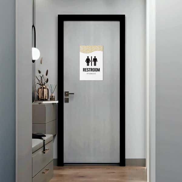 A 2-layer ADA sign for a restroom with a white foreground and the modern geometric background