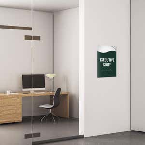 A 2-layer ADA sign for an executive suite with a green foreground and the basic swoop background