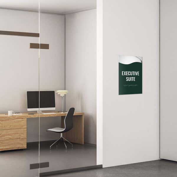 A 2-layer ADA sign for an executive suite with a green foreground and the basic swoop background