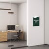 A 2-layer ADA sign for an executive suite with a green foreground and the basic swoop background