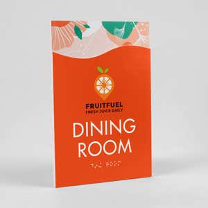 A 2-layer ADA sign for a dining room with an orange foreground and orange floral background sitting at an angle