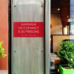 Custom ADA sign for a maximum occupancy warning