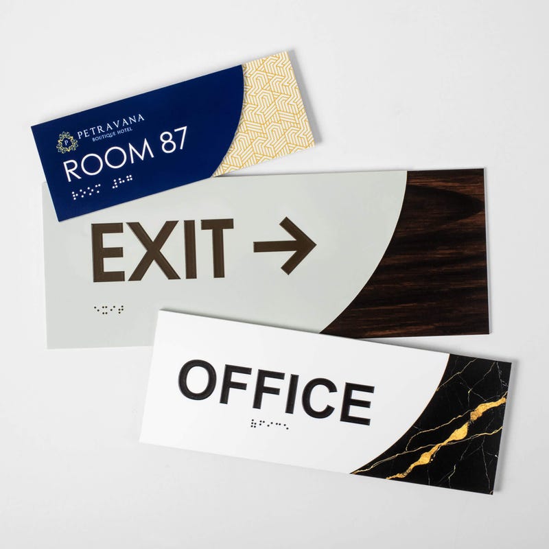 Three different sizes of the modern sleek 2-layer ADA sign next to each other