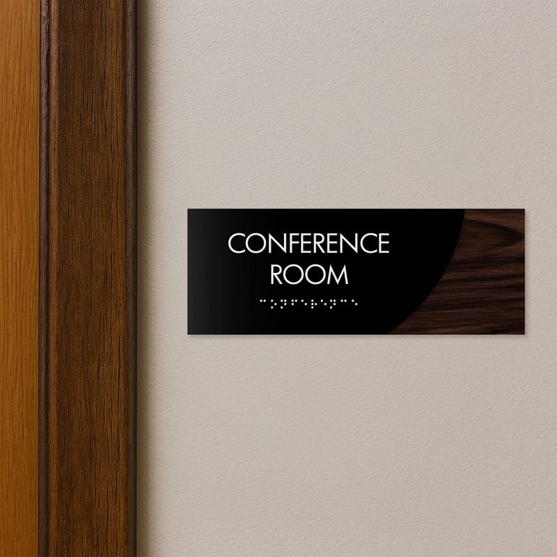 A 2-layer ADA sign for a conference room with a black foreground and a dark woodgrain background