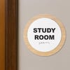 A 2-layer round ADA sign for a study room next to a doorframe