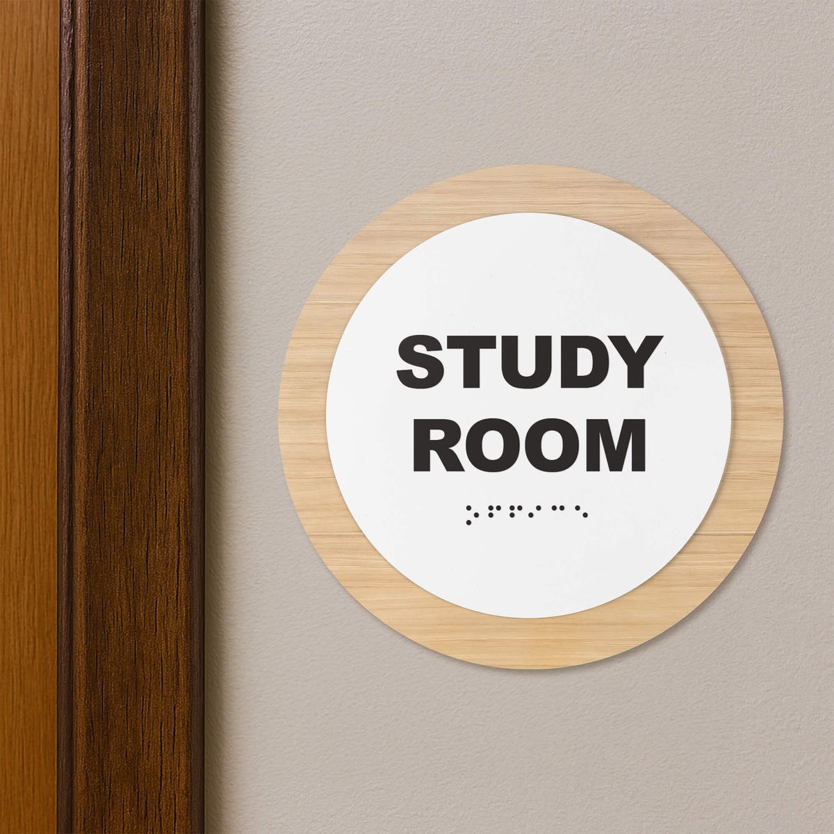 A 2-layer round ADA sign for a study room next to a doorframe