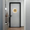 A large 2-layer round ADA sign for a restroom on the outside of a door