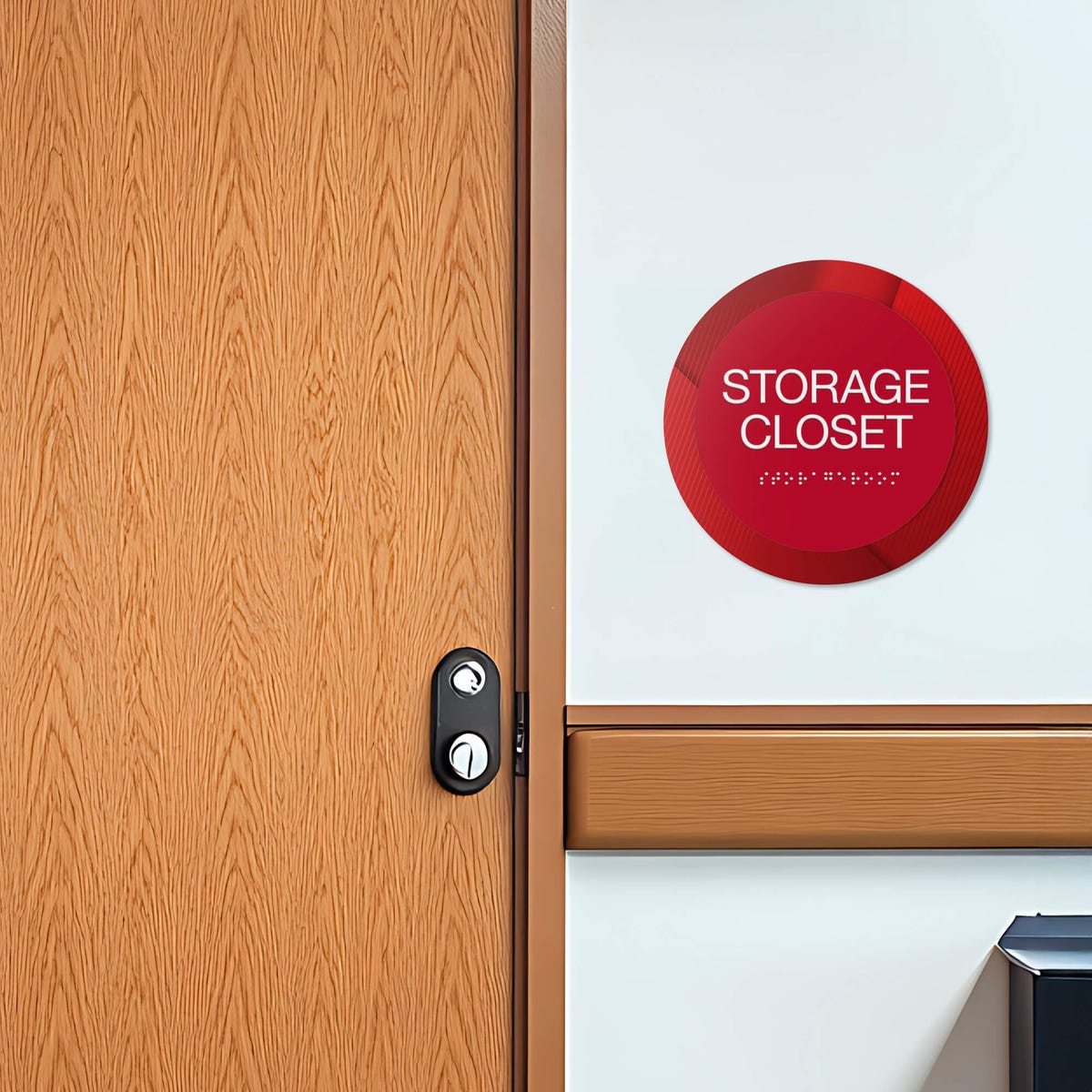 A 2-layer round ADA sign for a storage closet next to a doorway