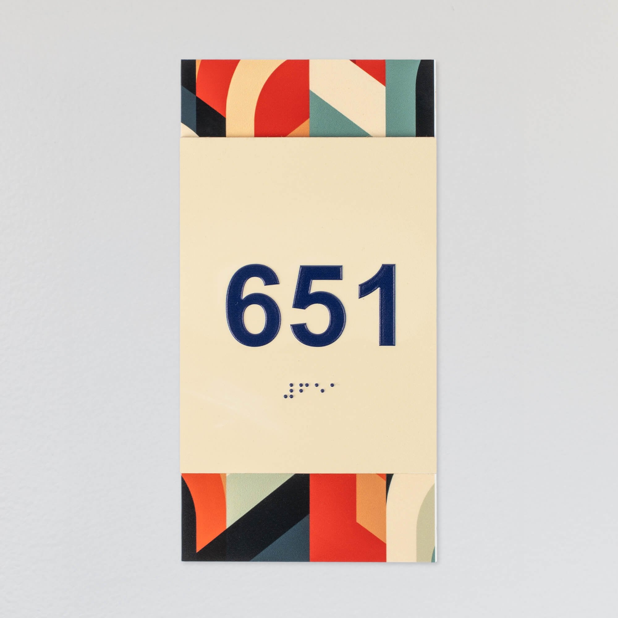 A design example of the 2-layer ADA sign with an ivory foreground and the multi geometric background