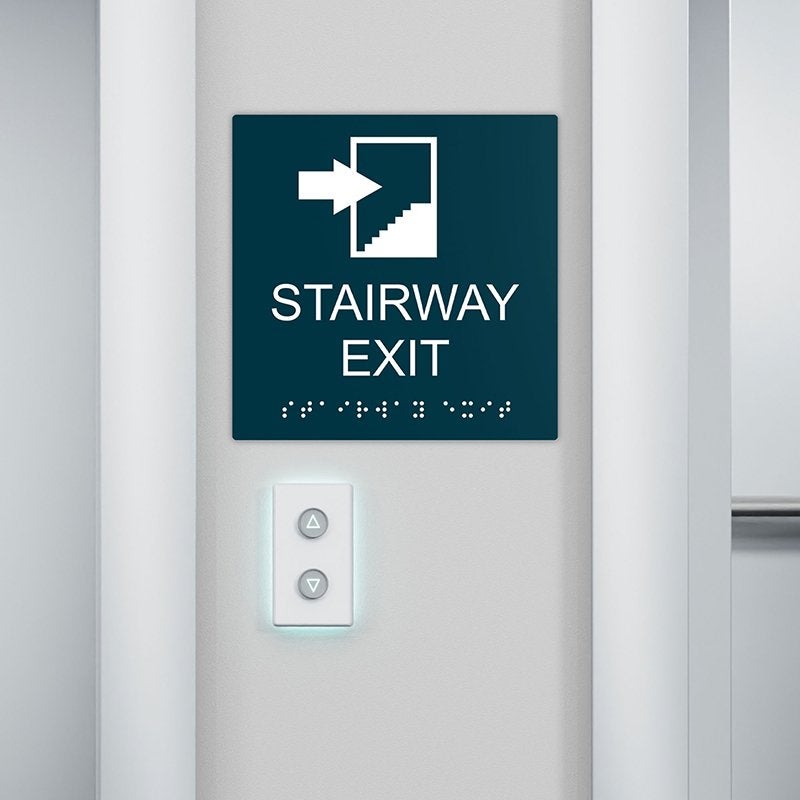 An ADA sign near stairs to show the stairway exit