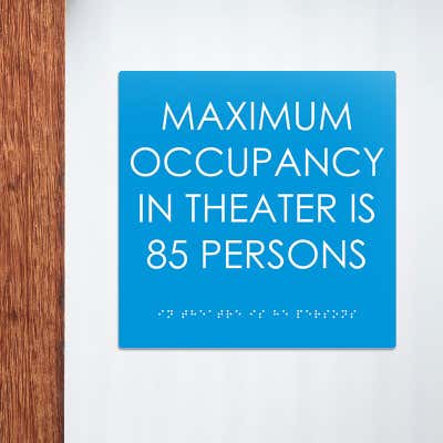 ADA sign for maximum occupancy in a theater