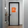 A large 2-layered ADA sign with an orange foreground and floral background for a restroom