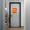 A large 2-layered ADA sign with an orange foreground and floral background for a restroom
