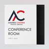 An example of a layered ADA sign design for a conference room with a white foreground and black geometric background