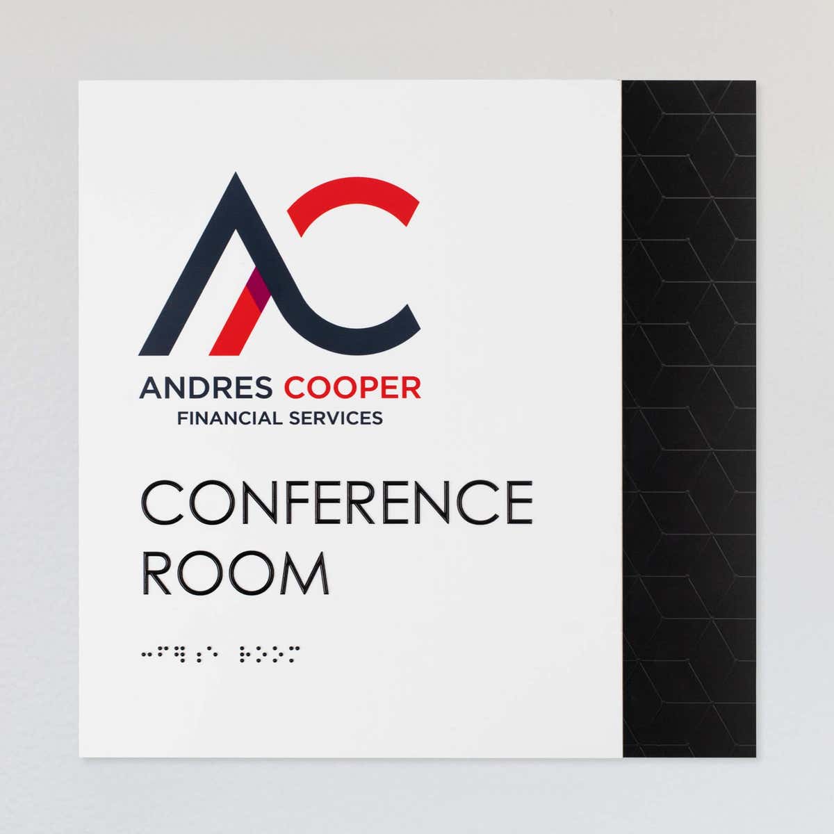 An example of a layered ADA sign design for a conference room with a white foreground and black geometric background