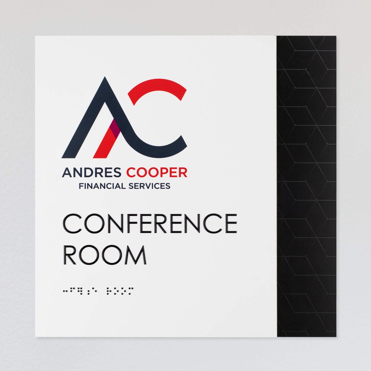 An example of a layered ADA sign design for a conference room with a white foreground and black geometric background