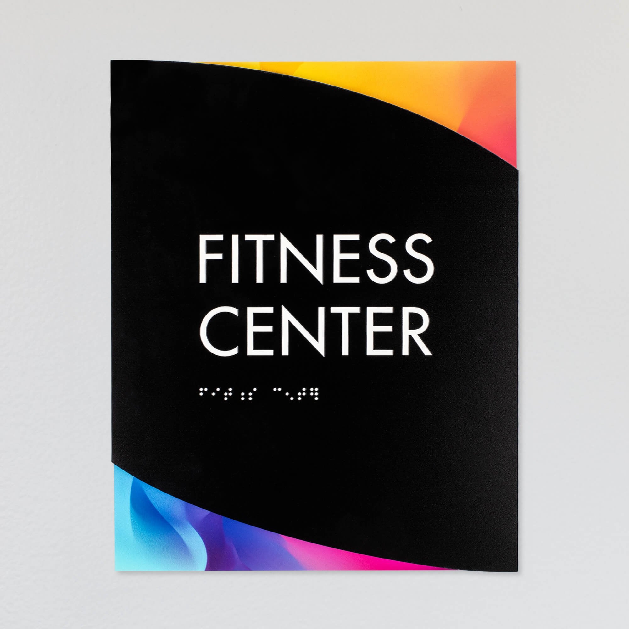 A design example of the modern twist ADA sign with the rainbow gradient background and black foreground for a fitness center