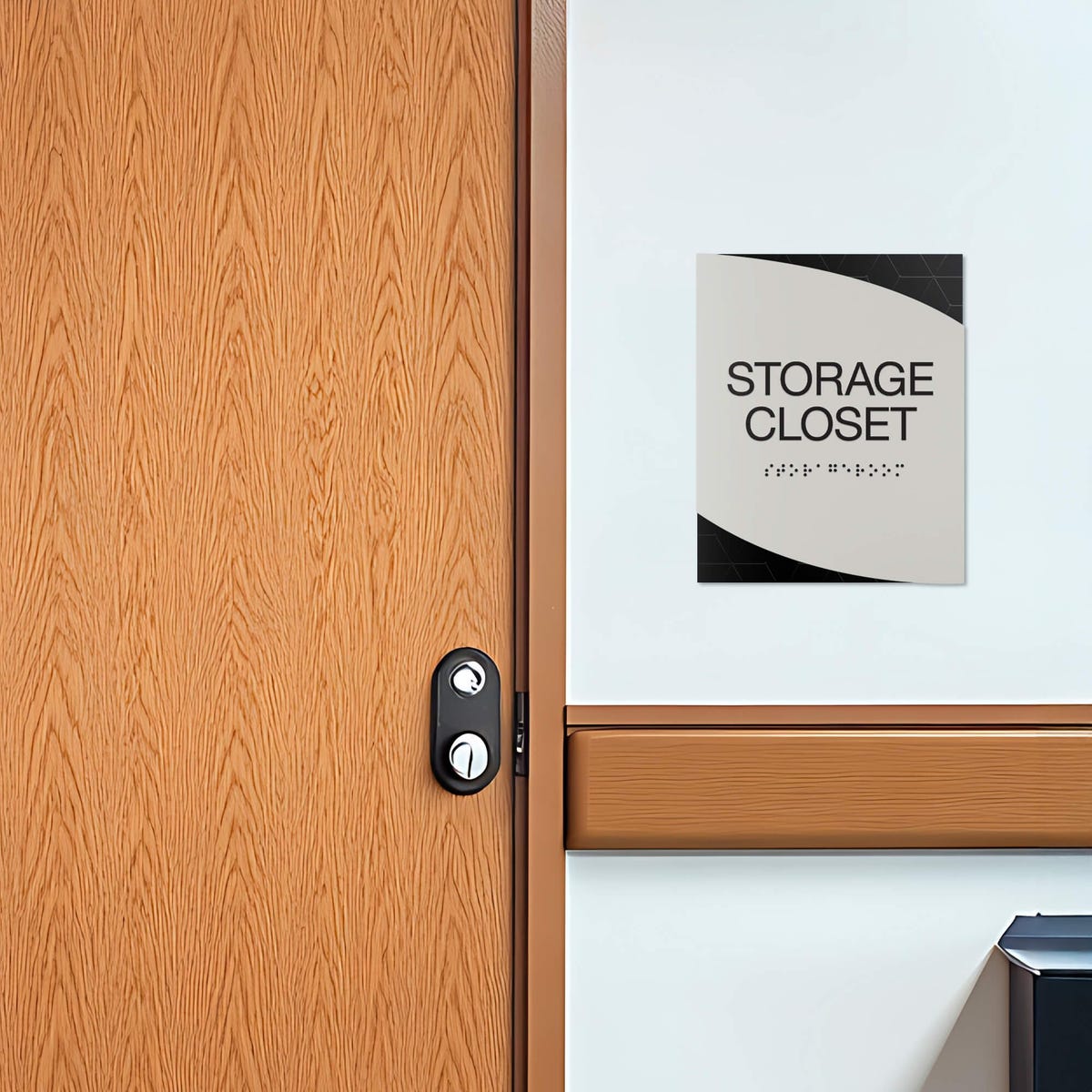 A modern twist design ADA sign for a storage closet with the black geometric background and gray foreground