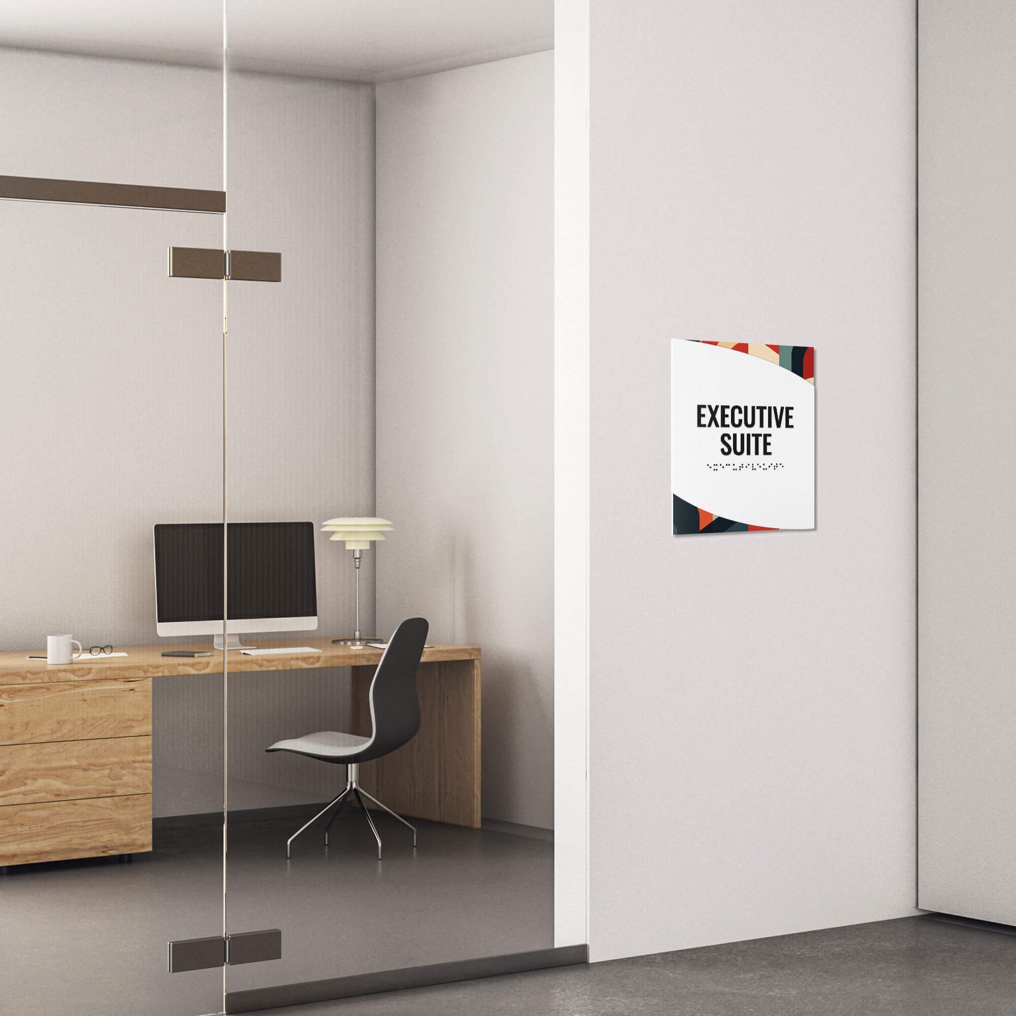 A modern twist design ADA sign for an executive suite with a multi geometric background and white foreground