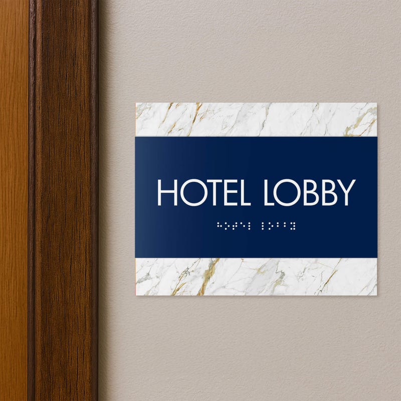 A 2-layered horizontal ADA sign for a hotel lobby with a blue foreground and white marble background