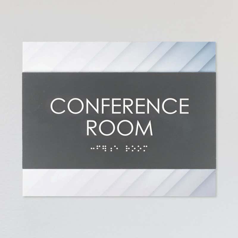 A design example of the horizontal 2-layer ADA sign for a conference room with a gray foreground and minimal diagonal background