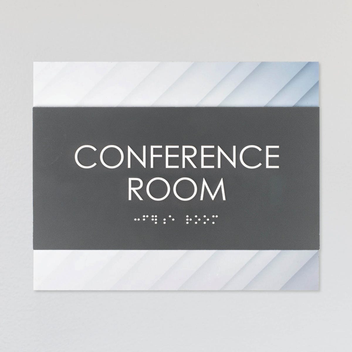 A design example of the horizontal 2-layer ADA sign for a conference room with a gray foreground and minimal diagonal background
