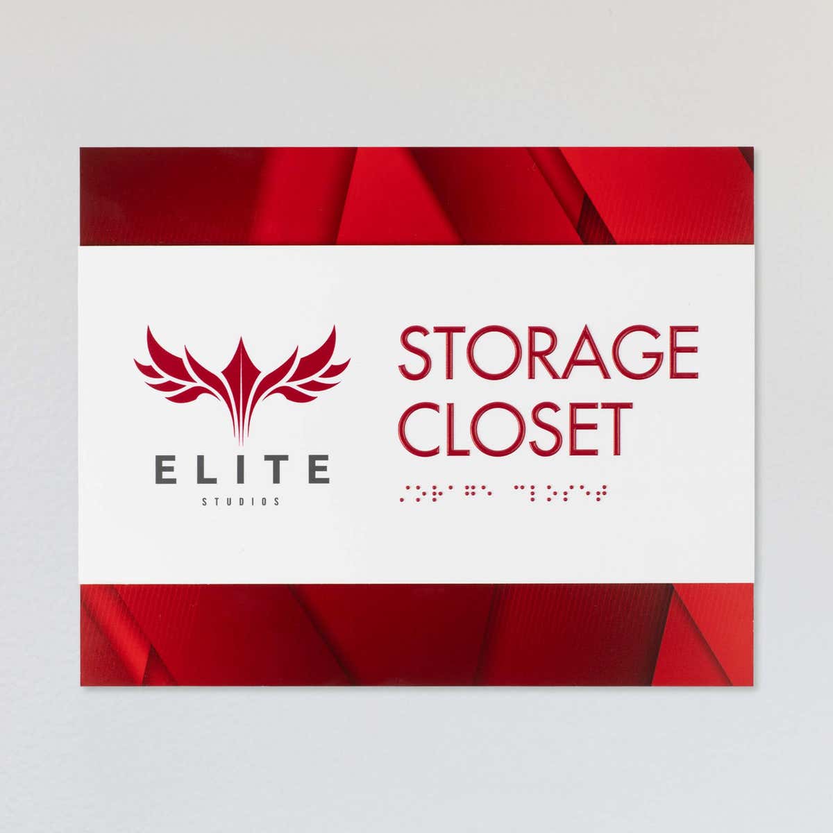 An example of the 2-layer horizontal ADA sign for a storage closet with a white foreground and red gradient background
