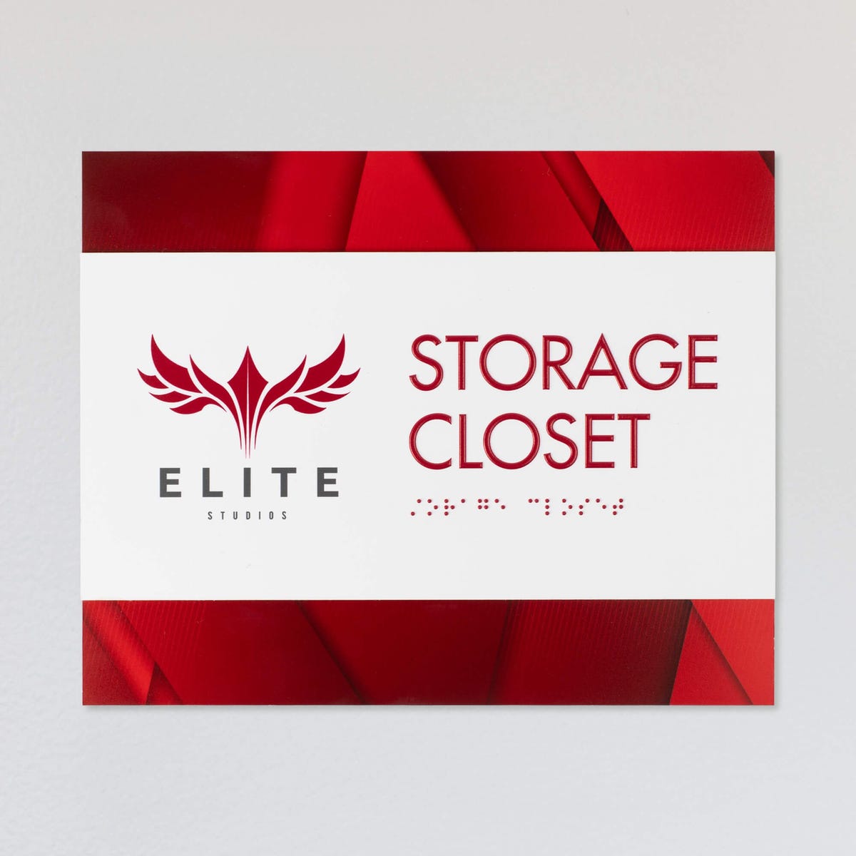 An example of the 2-layer horizontal ADA sign for a storage closet with a white foreground and red gradient background