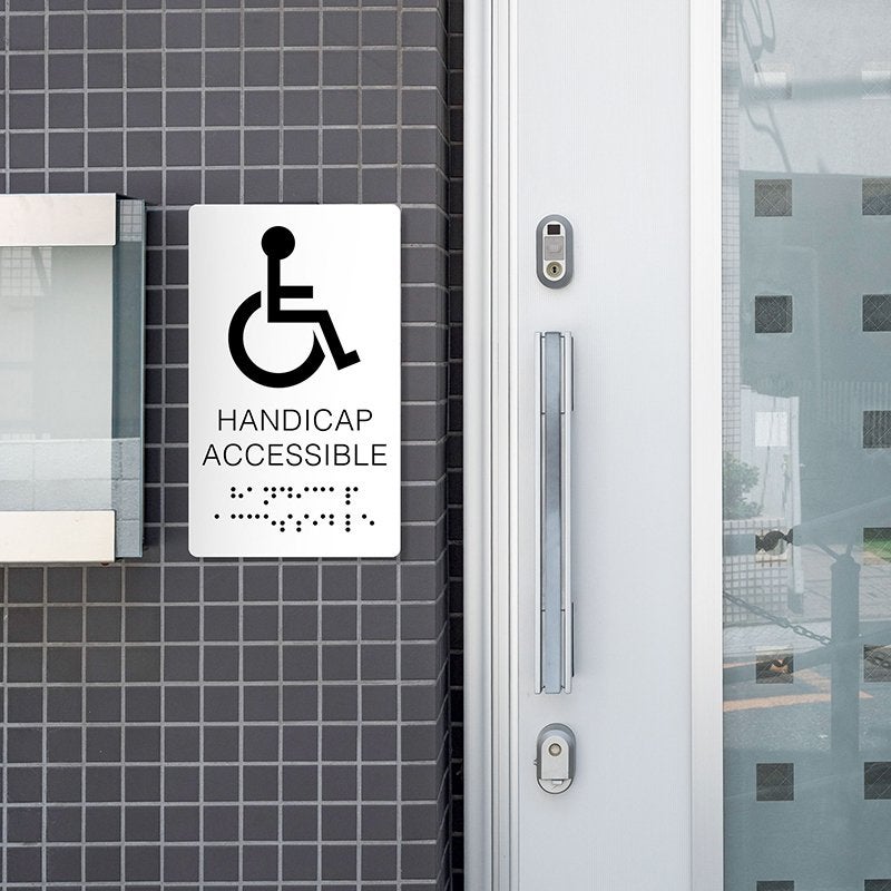 A white ADA sign for a handicap accessible entrance