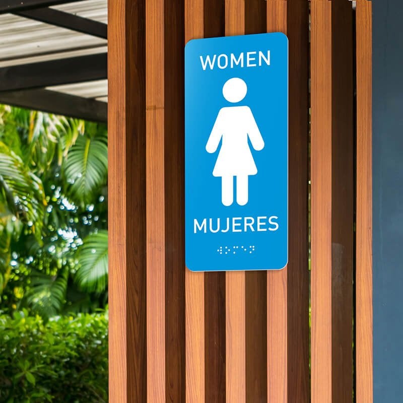 Custom ADA sign for a women's restroom with English and Spanish text