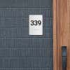A gray ADA sign with a room number